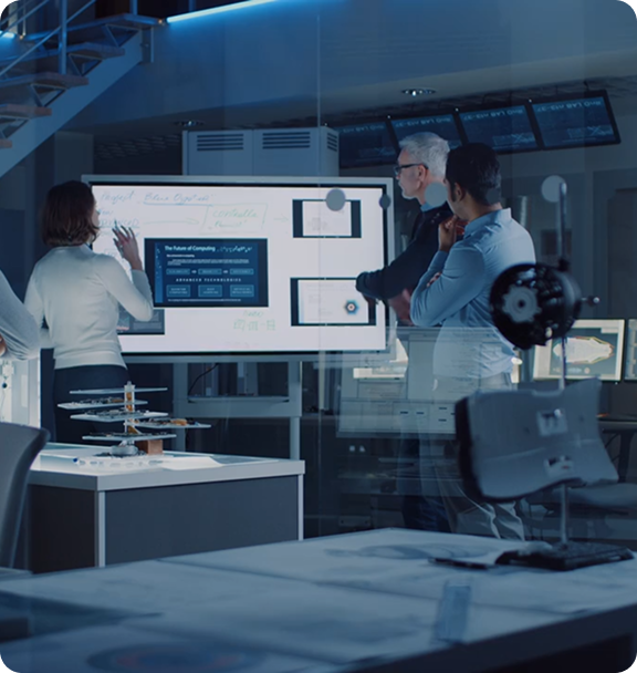 Professionals reviewing data in server room